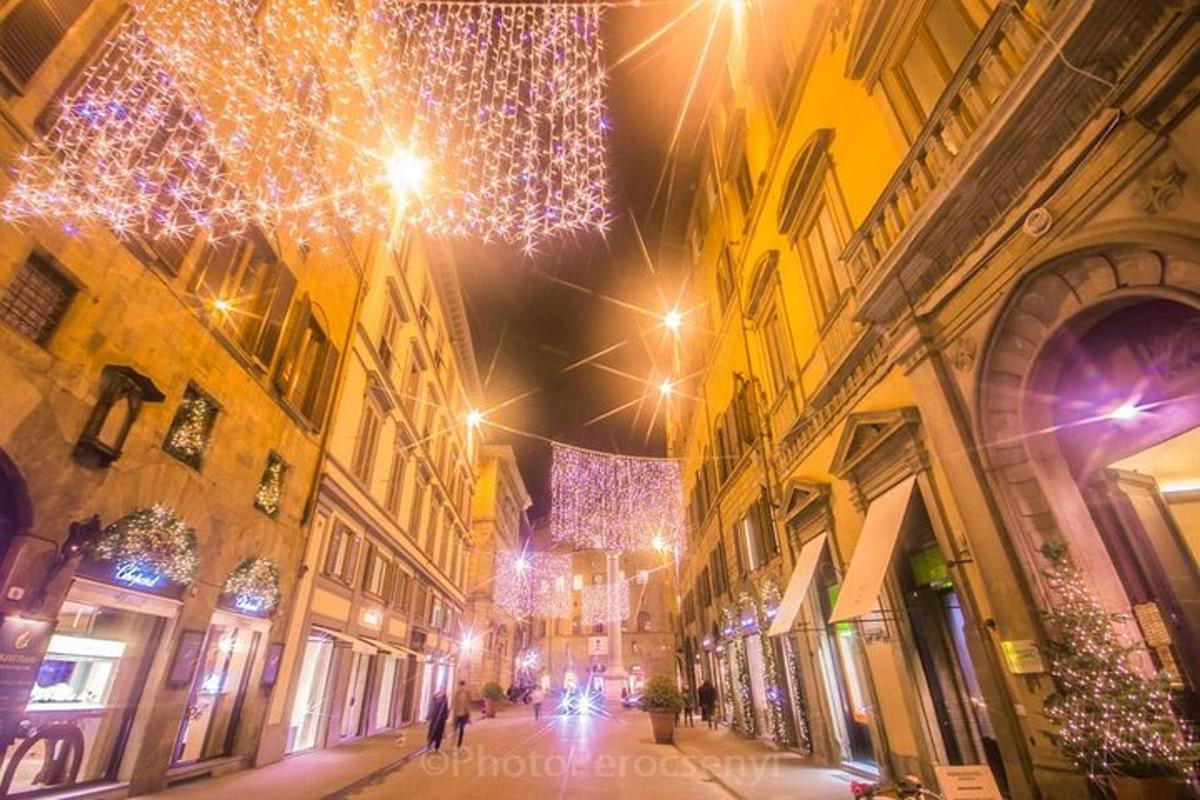 a city street at night with christmas lights