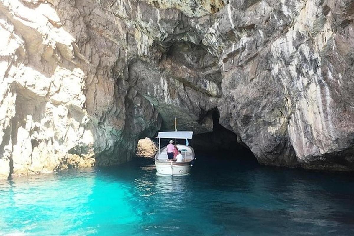 a person in a boat in front of a cave