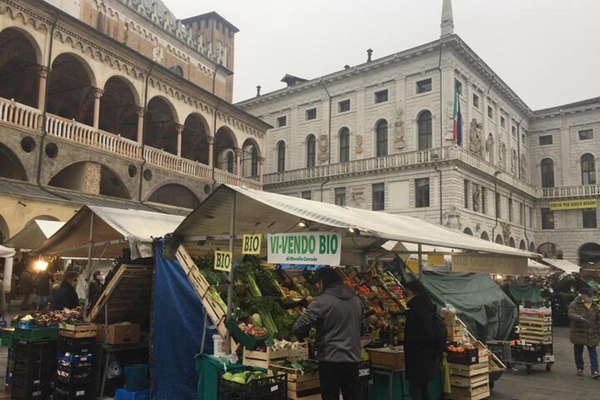 a market with fruits and vegetables in front of a building