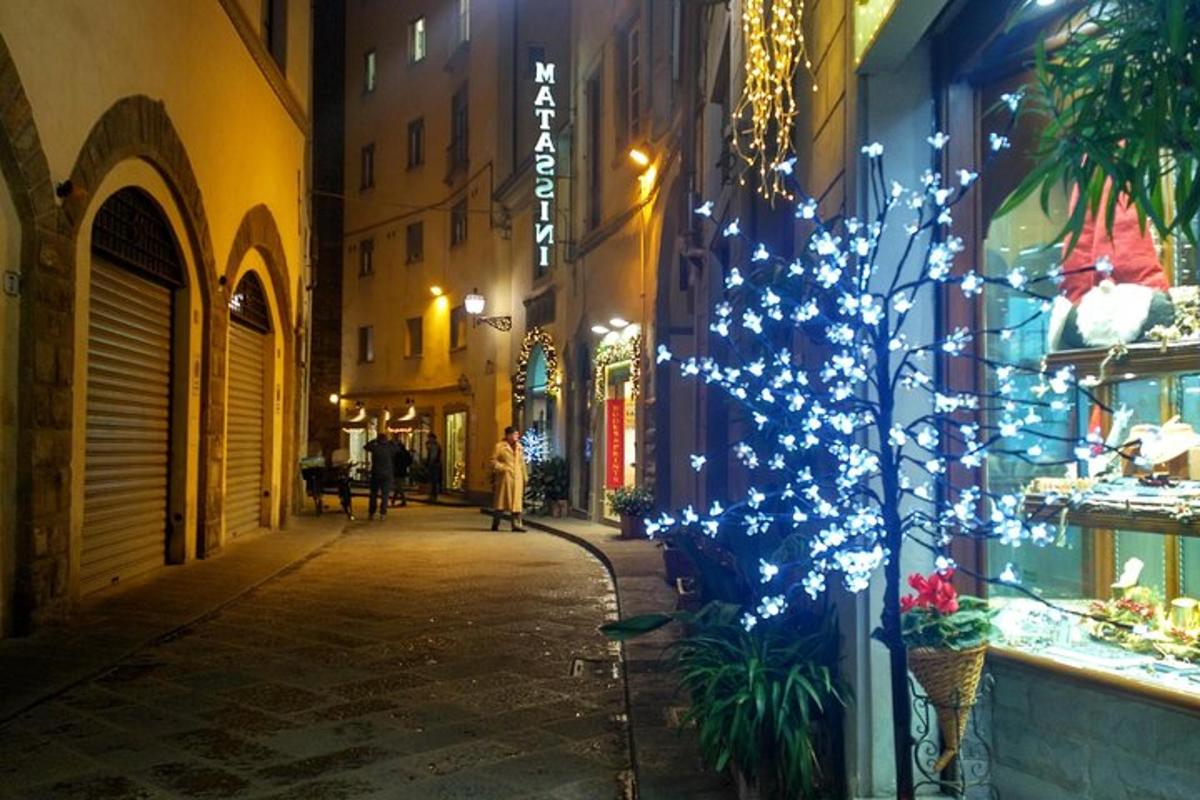 a street with a christmas tree on the side of a building