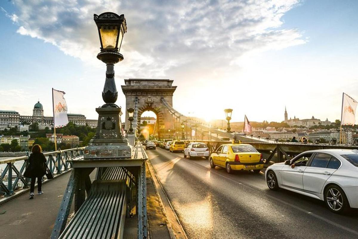 a street light on a bridge with cars on the road