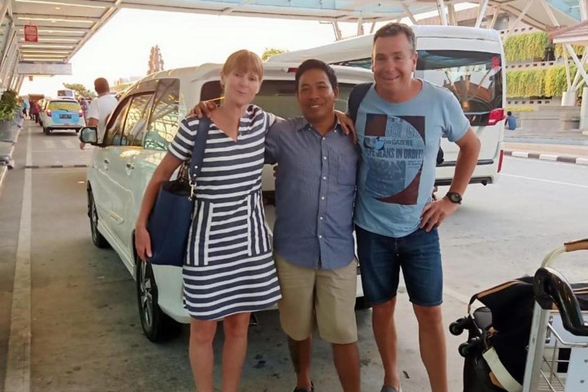 un bărbat și o femeie stând lângă o mașină