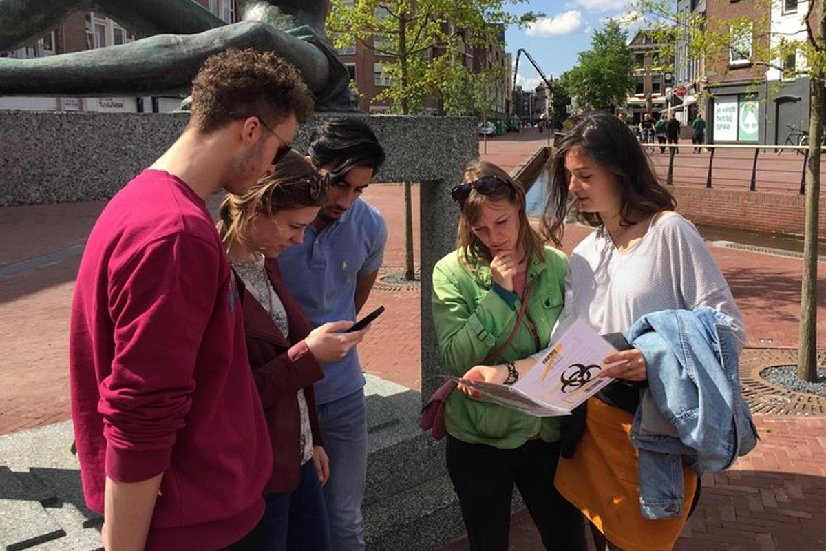 a group of people looking at a cell phone