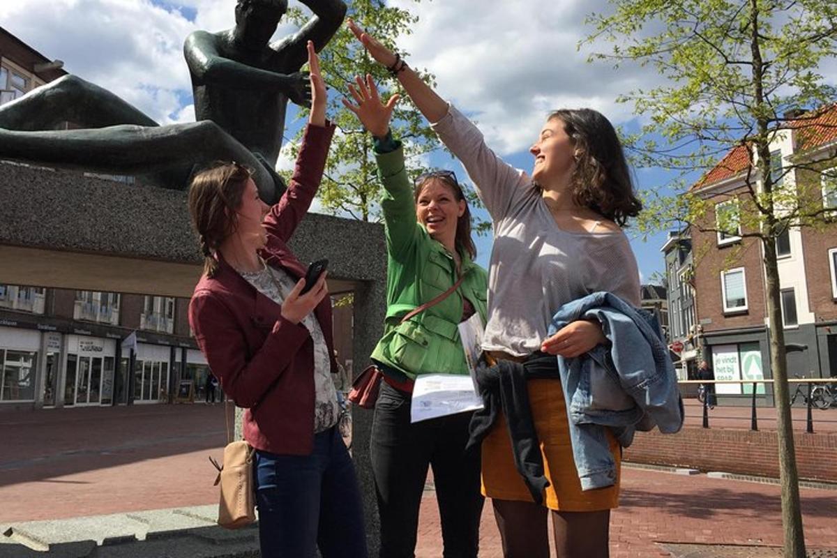 three women standing in front of a statue