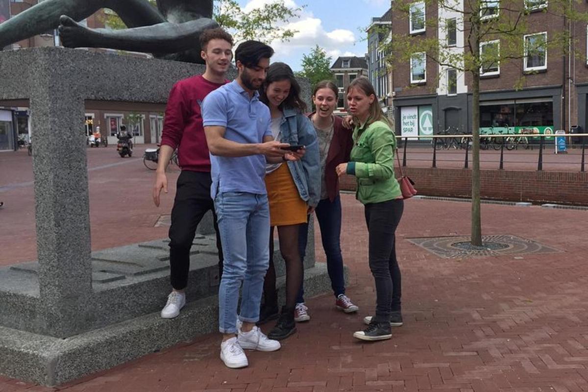 a group of people standing next to a statue