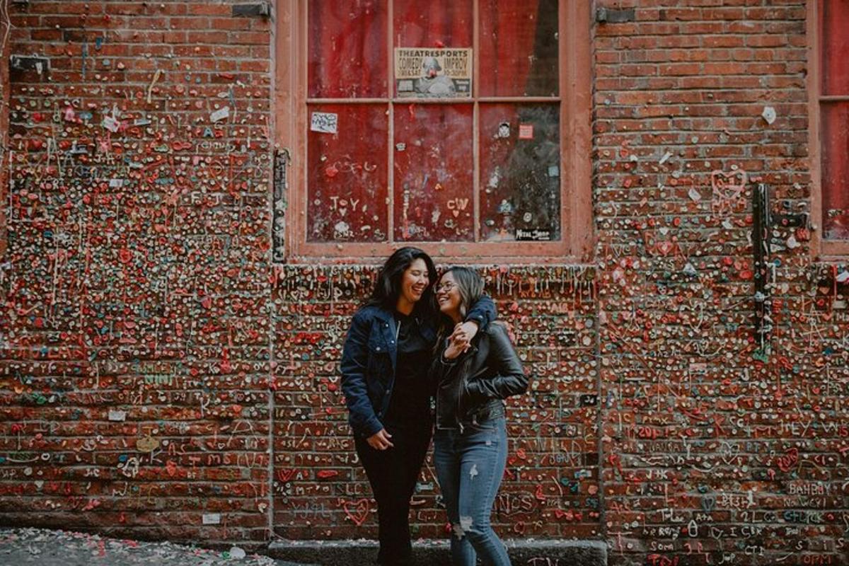due donne in piedi davanti a un muro di mattoni