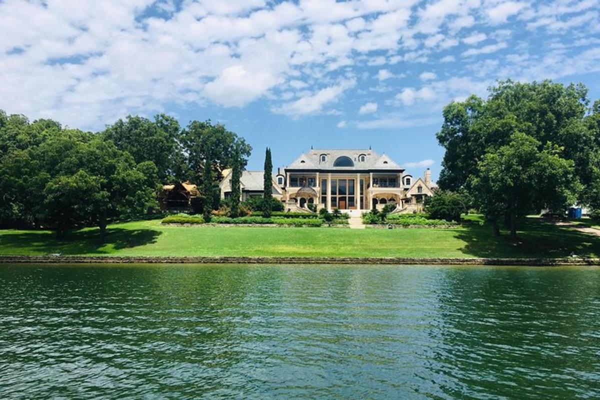 a large house sitting on the shore of a lake