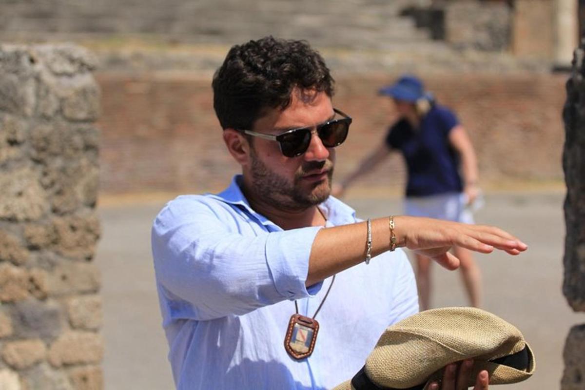 a man wearing sunglasses and a tag pointing at something