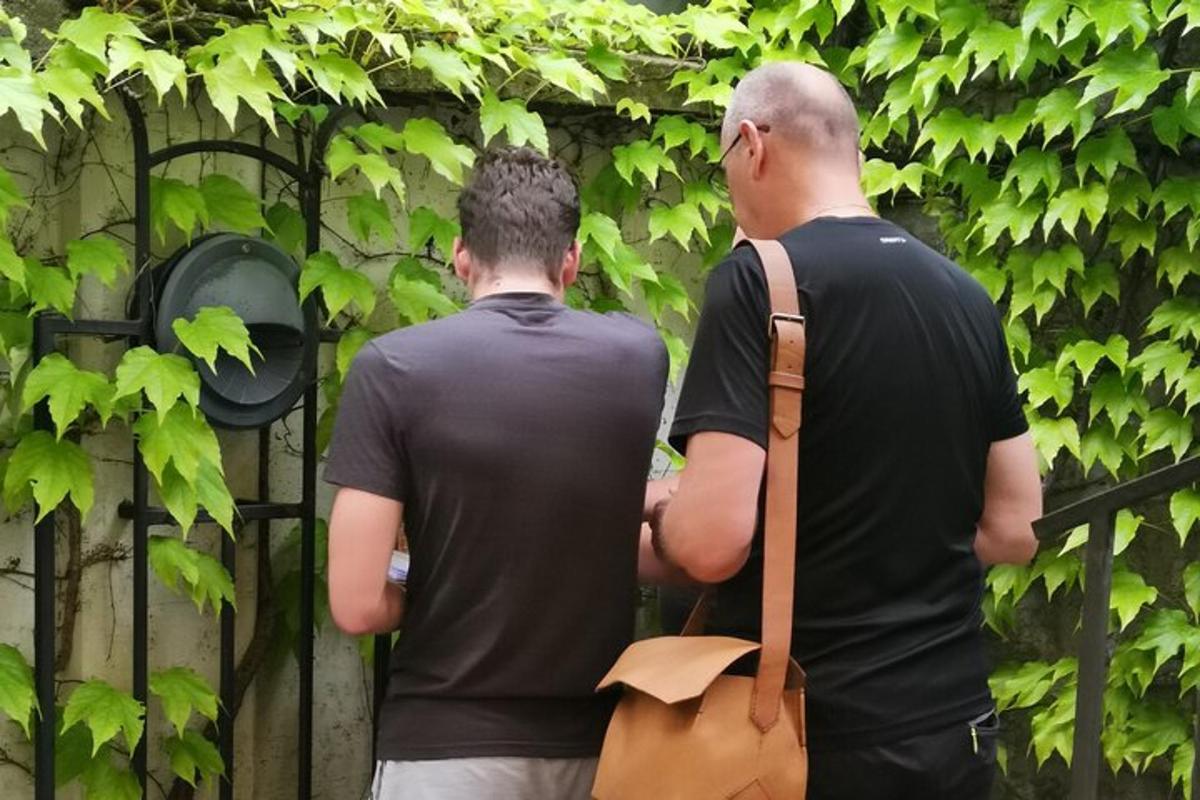 two men standing in front of a fence