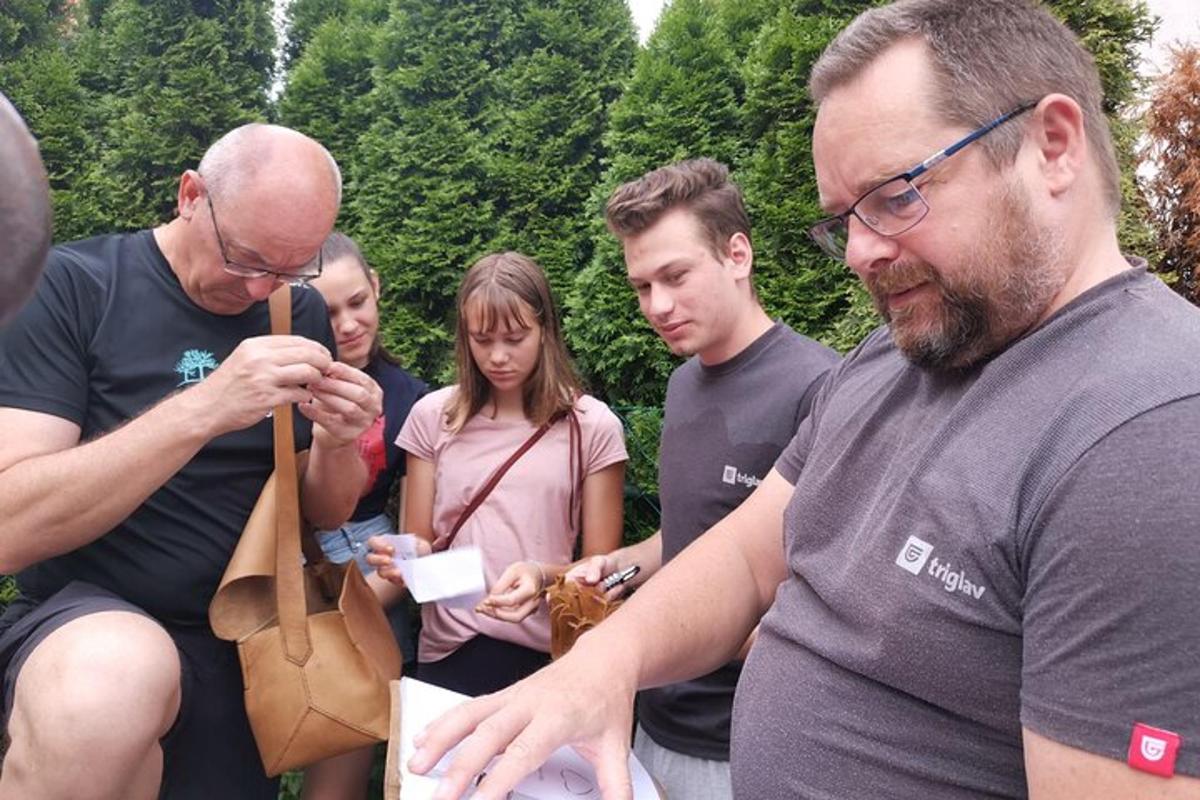 a group of people standing around a man holding a bag