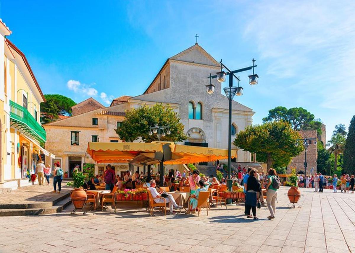 a group of people sitting at tables in front of a building