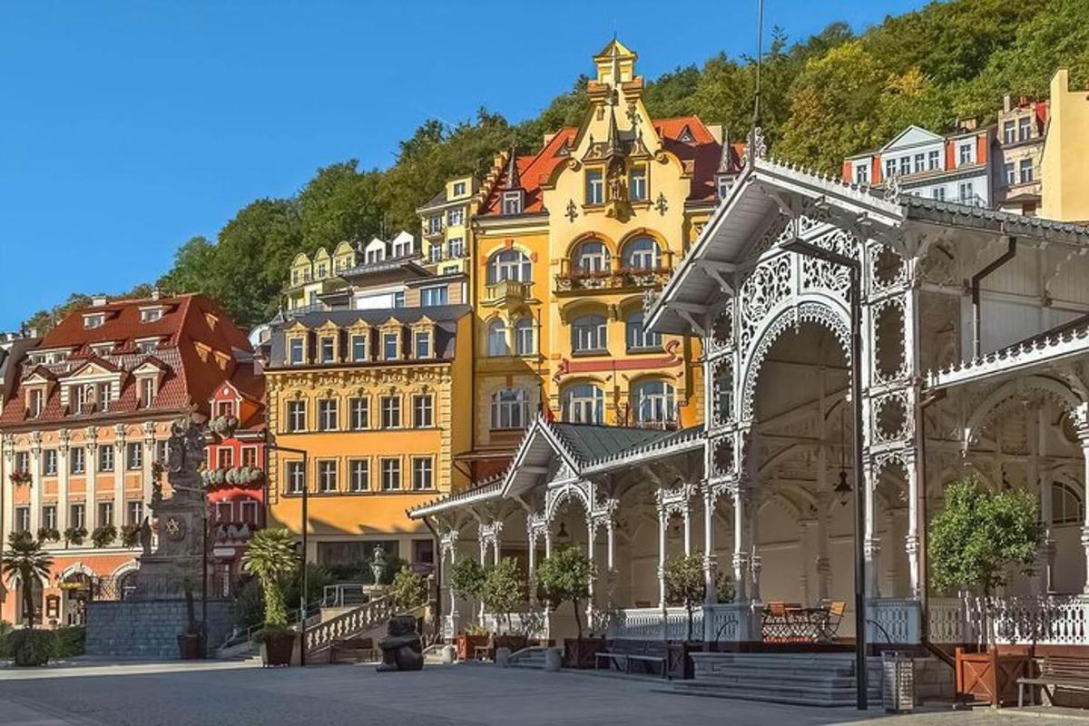 a group of buildings in front of a mountain