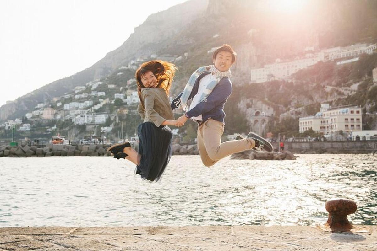a man and woman jumping in the water