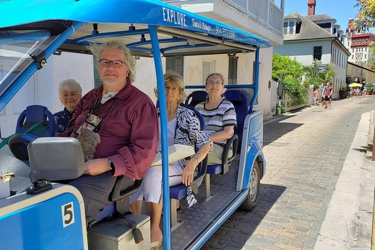 a group of people riding on a small train