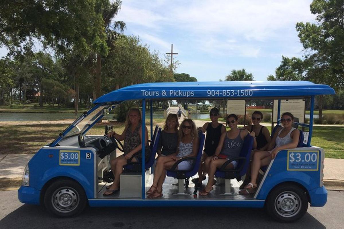 a group of women sitting in a golf cart