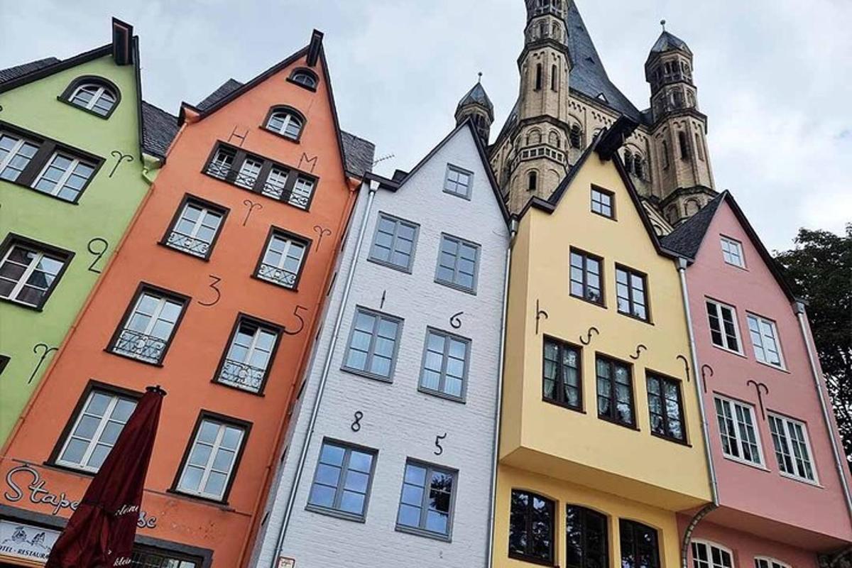 a row of colorful buildings in front of a church