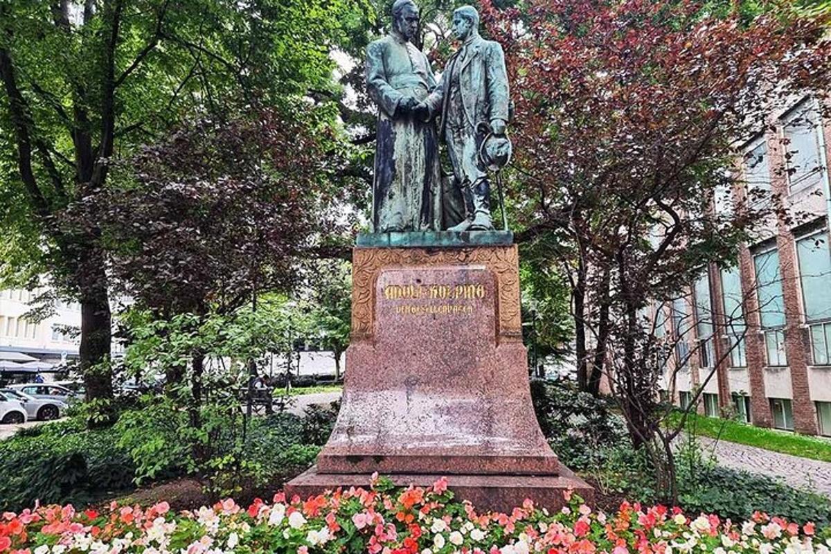 a statue of two people standing in a park