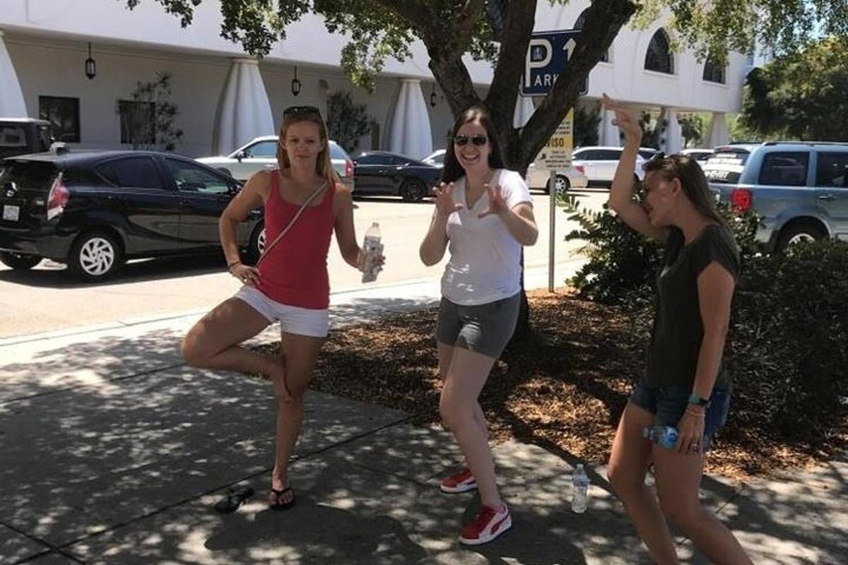 a group of three women standing on a sidewalk