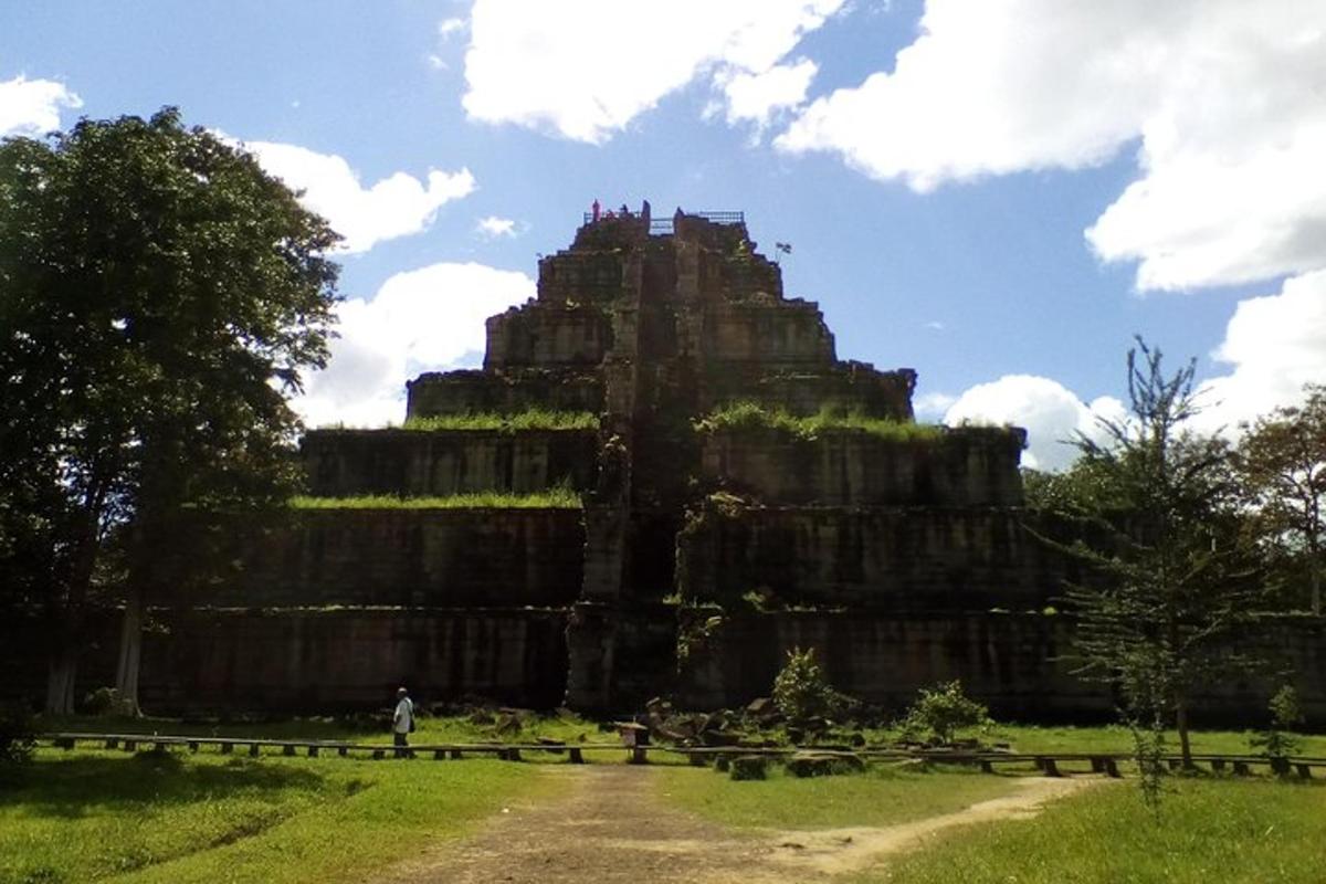 a large stone building in a field with a sky