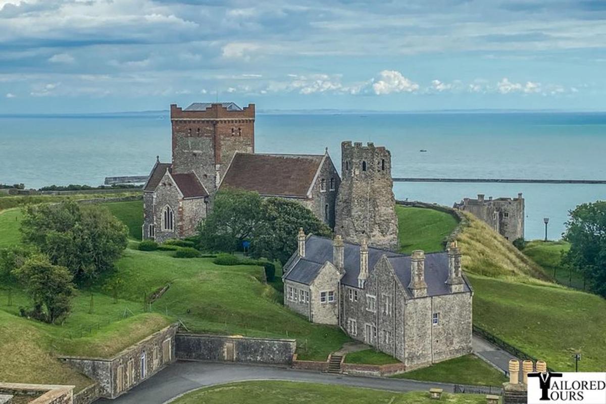 an old castle on a hill next to the ocean