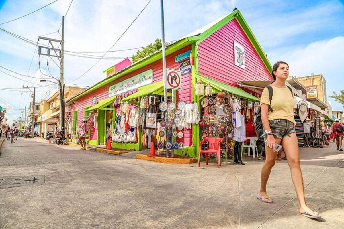 a woman standing in front of a colorful building on a street