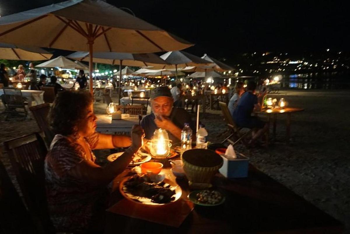 a man and a woman sitting at a table with food