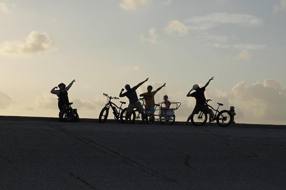 a group of people on bikes with their arms in the air