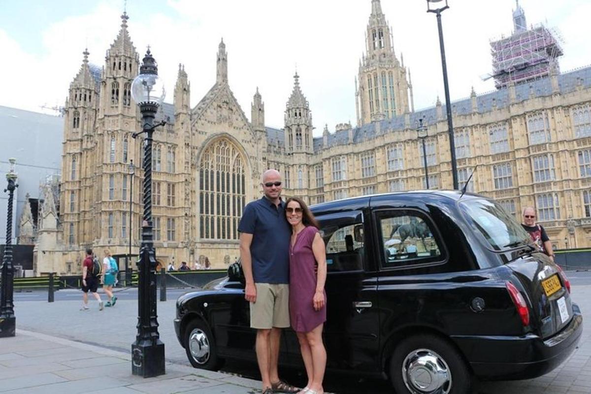 a man and a woman standing next to a black car