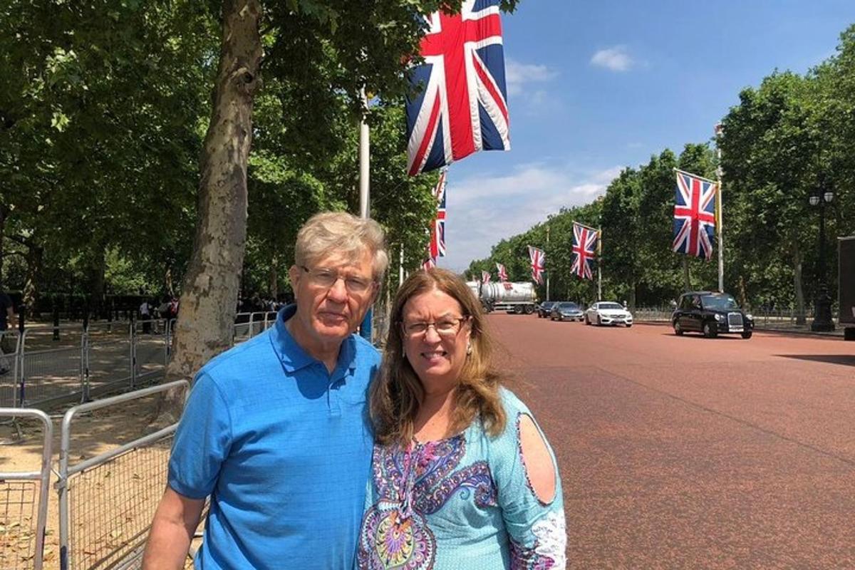 a man and a woman standing in front of a street with flags