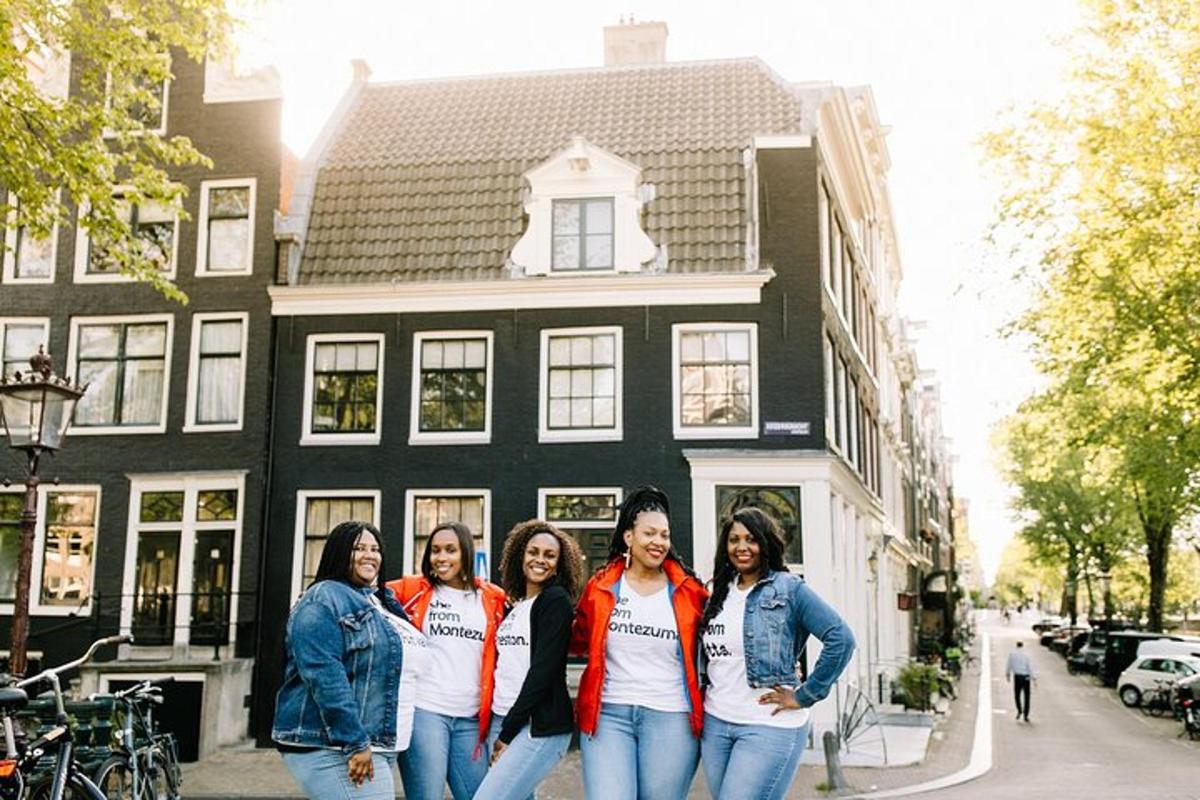 a group of women standing in front of a house