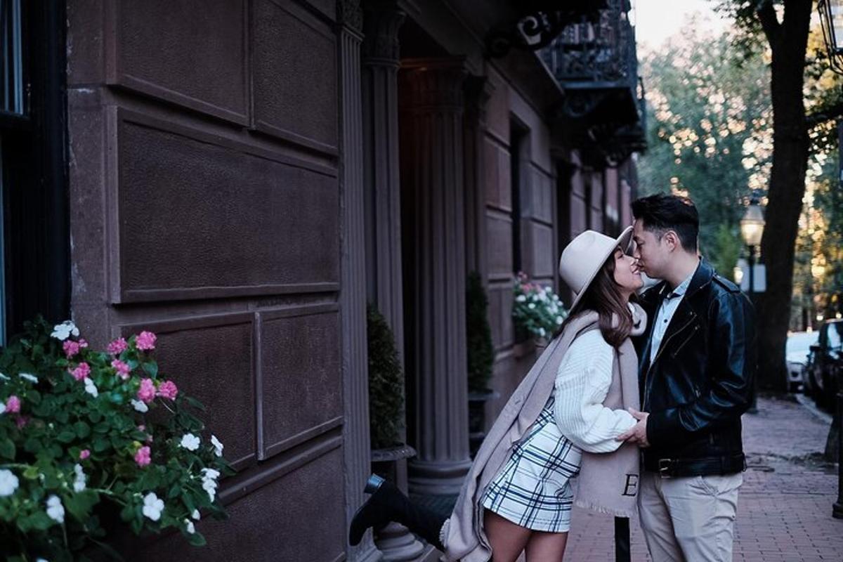 a man and a woman kissing on a sidewalk
