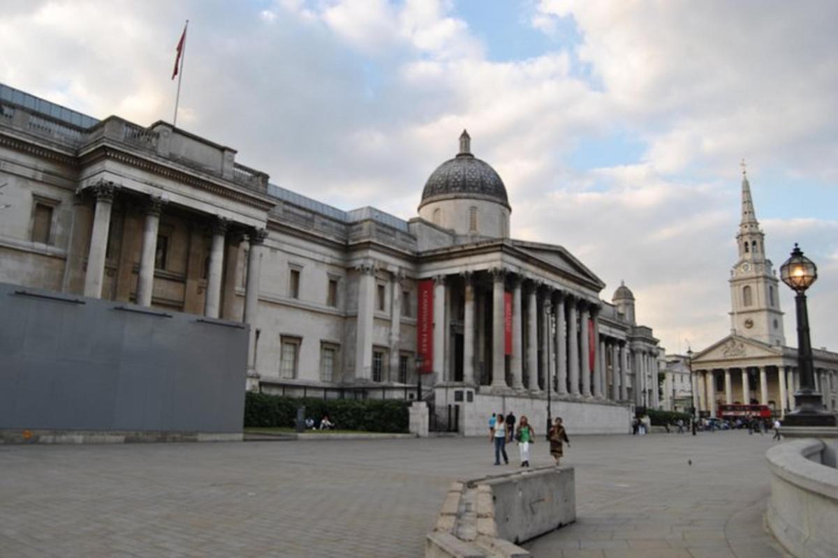 a large building with people walking in front of it