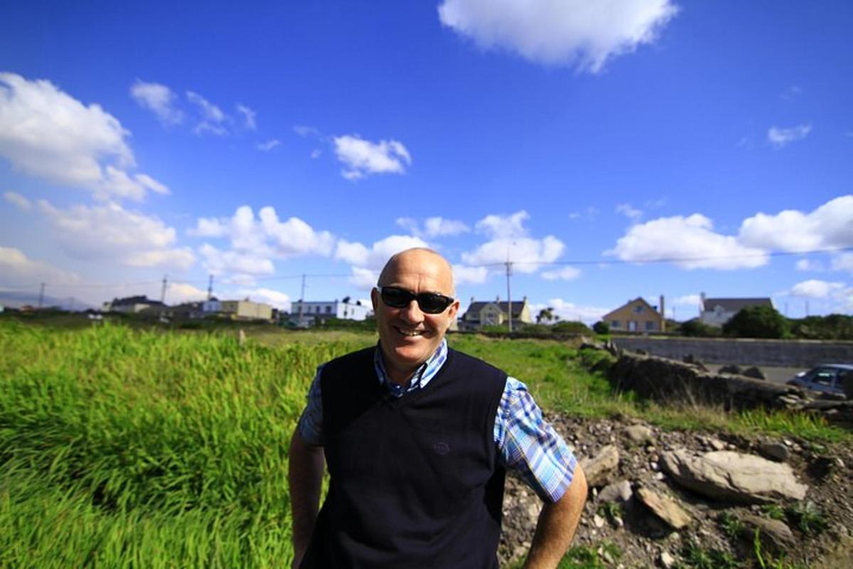 a man wearing sunglasses is standing in a field