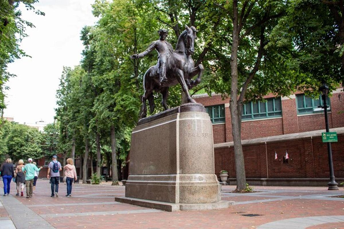 a statue of a woman on a horse in front of a building