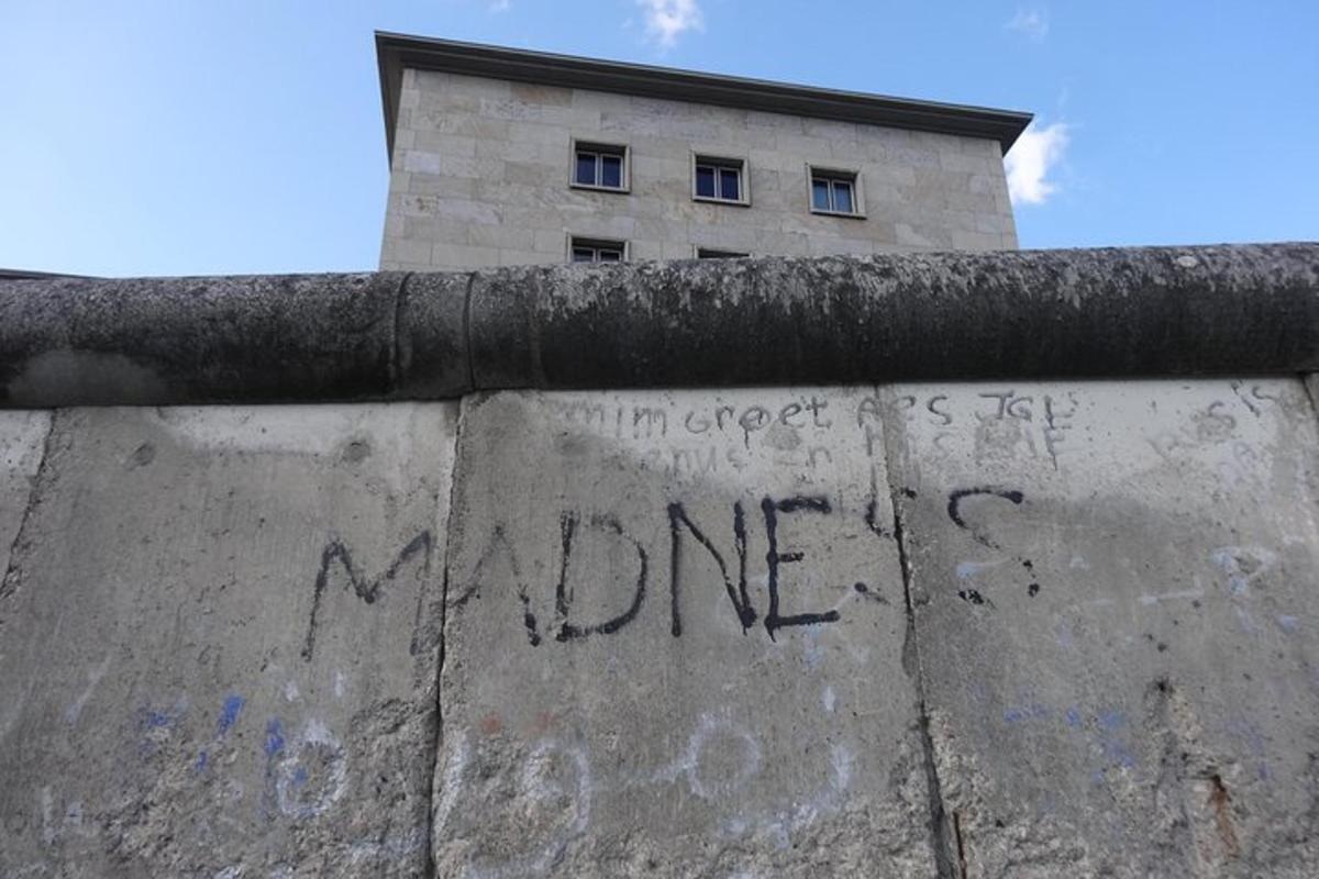 a wall with graffiti on it in front of a building