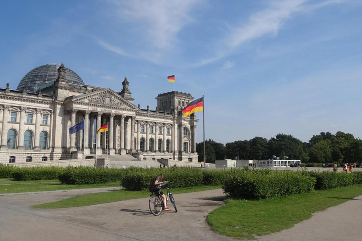 a person riding a bike in front of a building