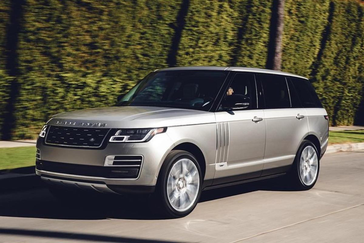 a silver suv driving down a road