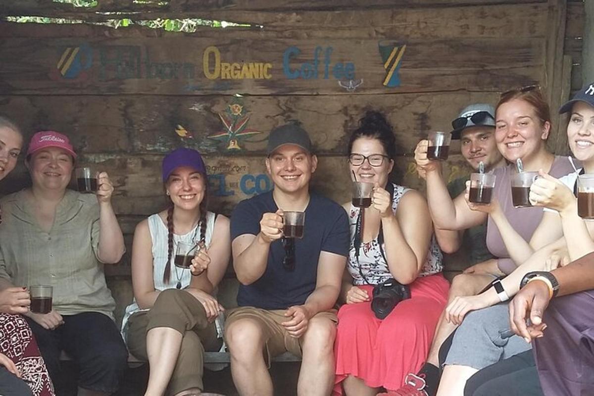 a group of people sitting together holding up drinks