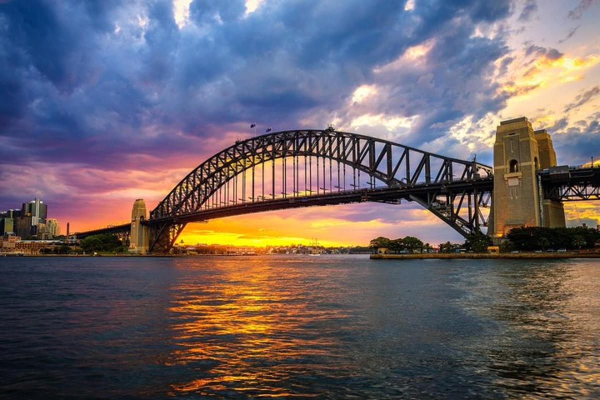 a bridge over a body of water with a sunset