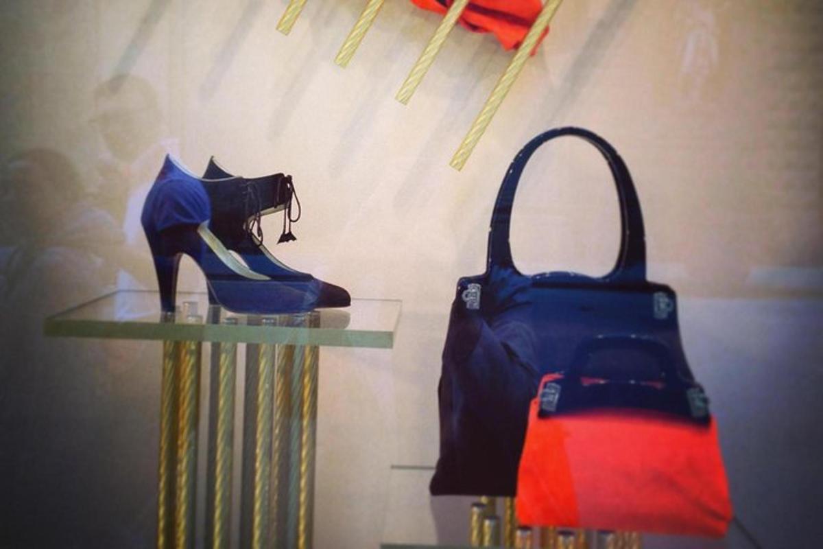 a display of a woman in blue shoes and a purse