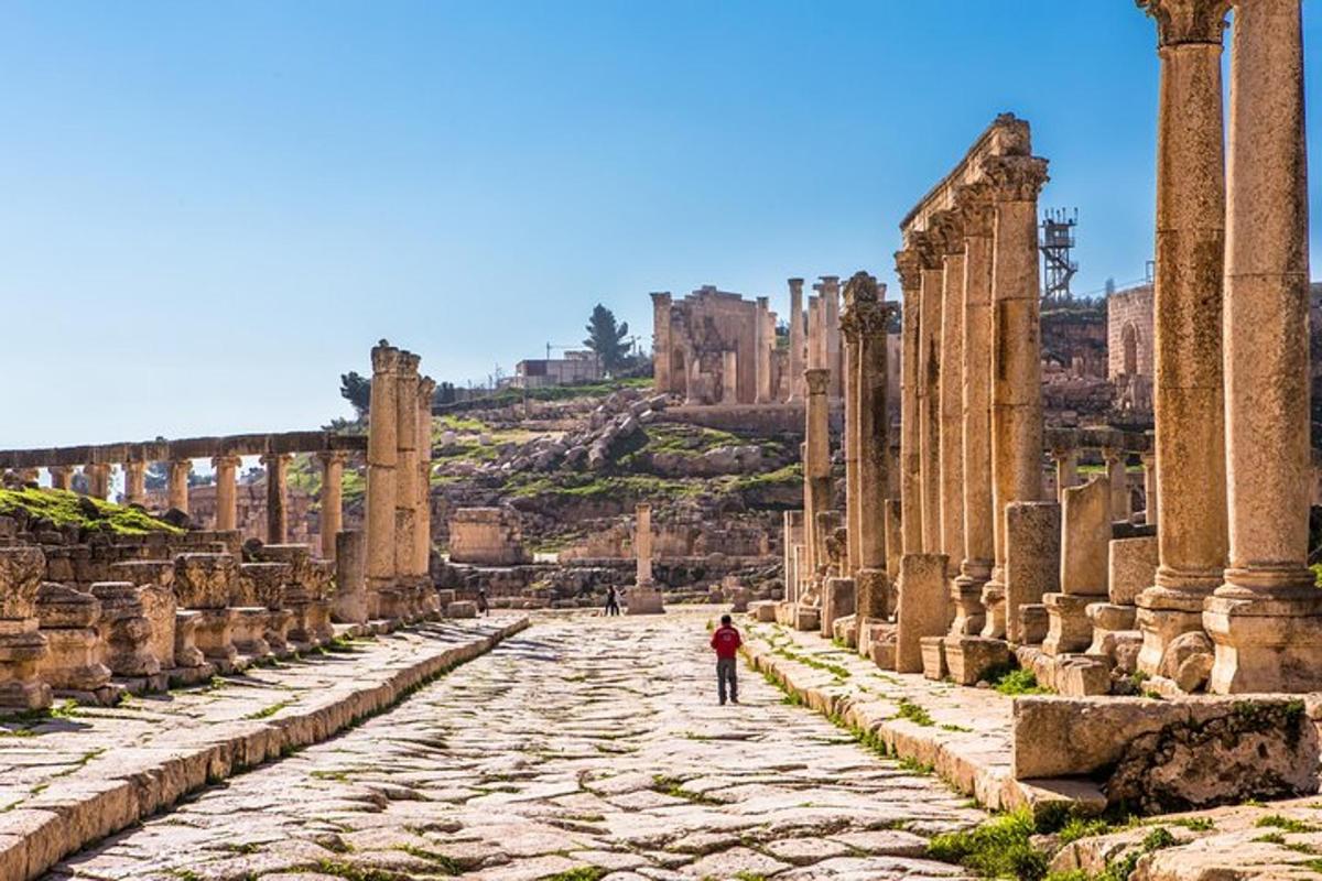 a person walking down a street in the ruins