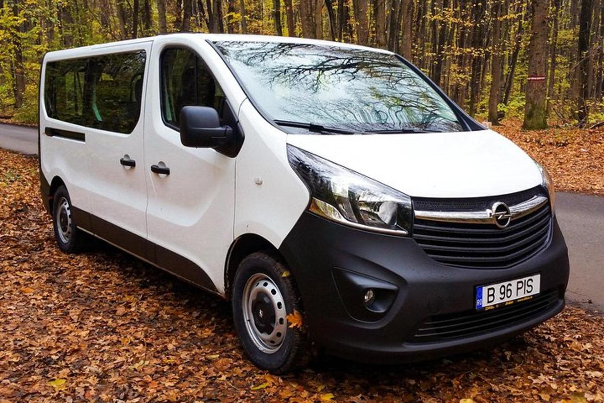 a small white van parked on the side of a road