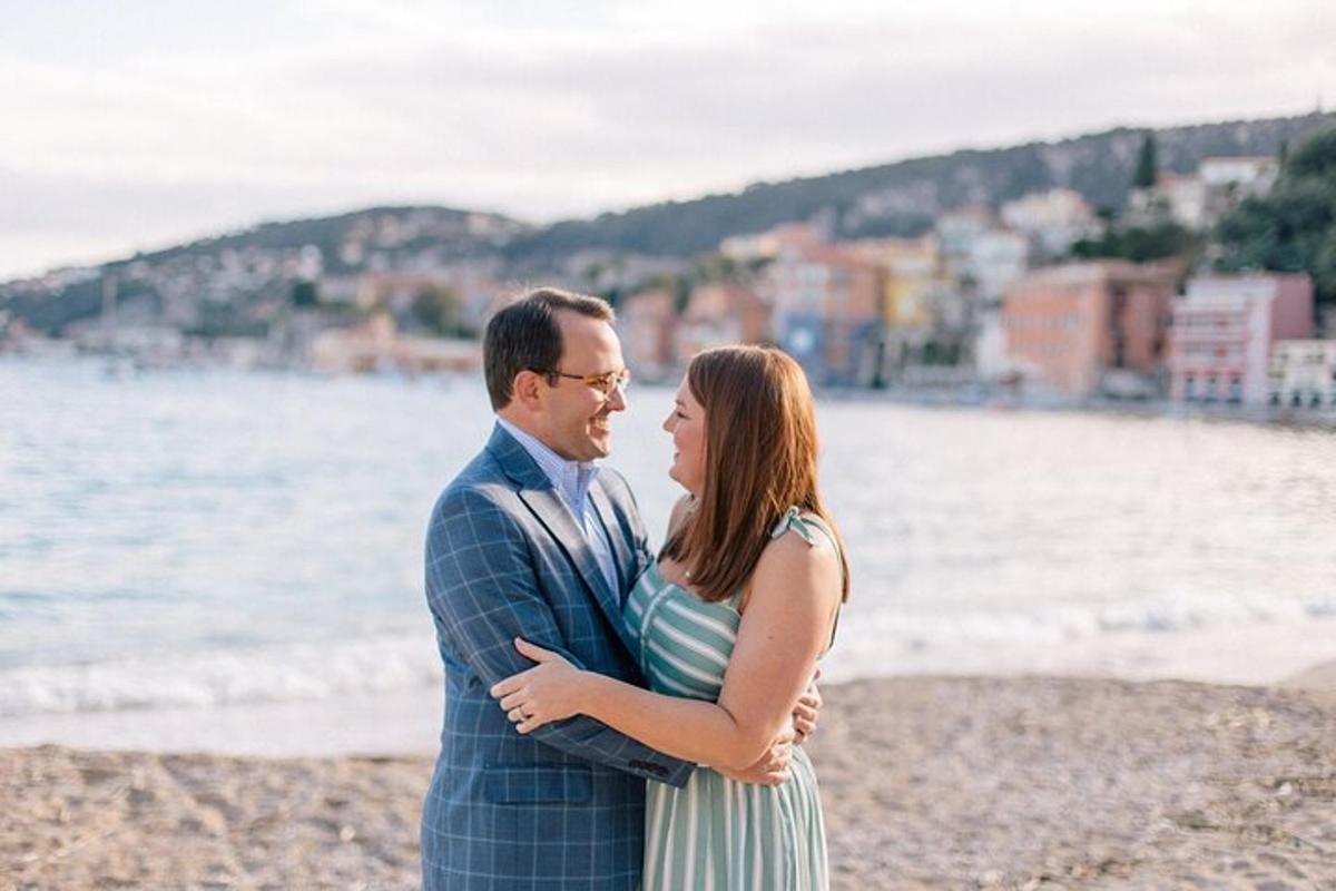 a man and a woman standing on the beach