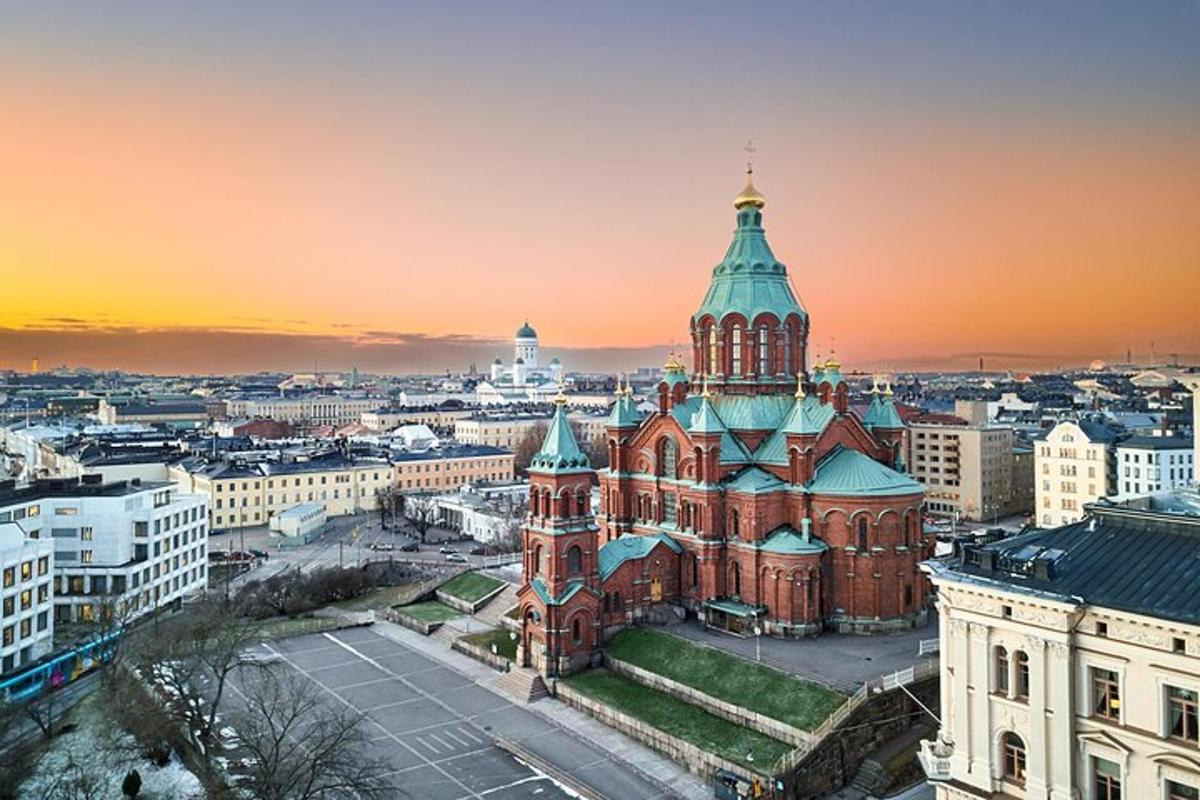an old building with a tower in a city at sunset