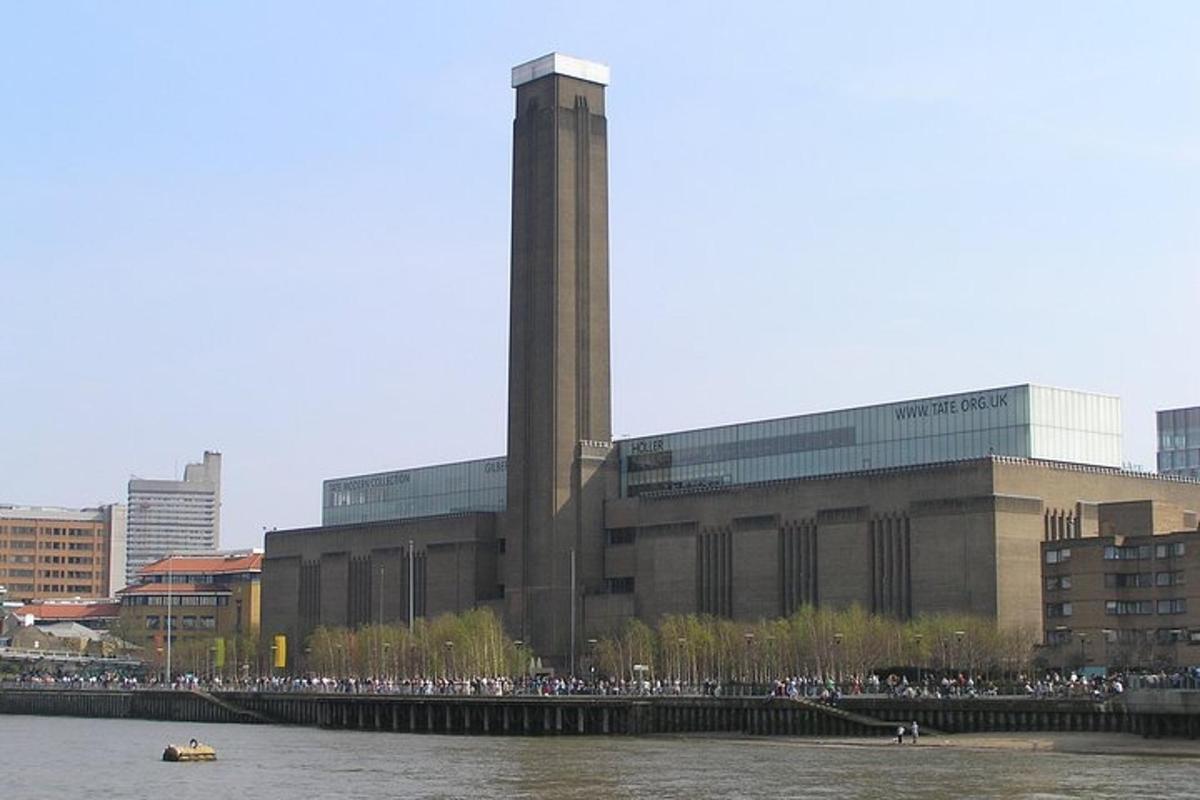 a large building with a clock tower next to a river