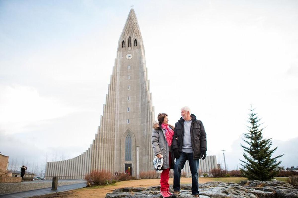 a man and a woman standing in front of a church