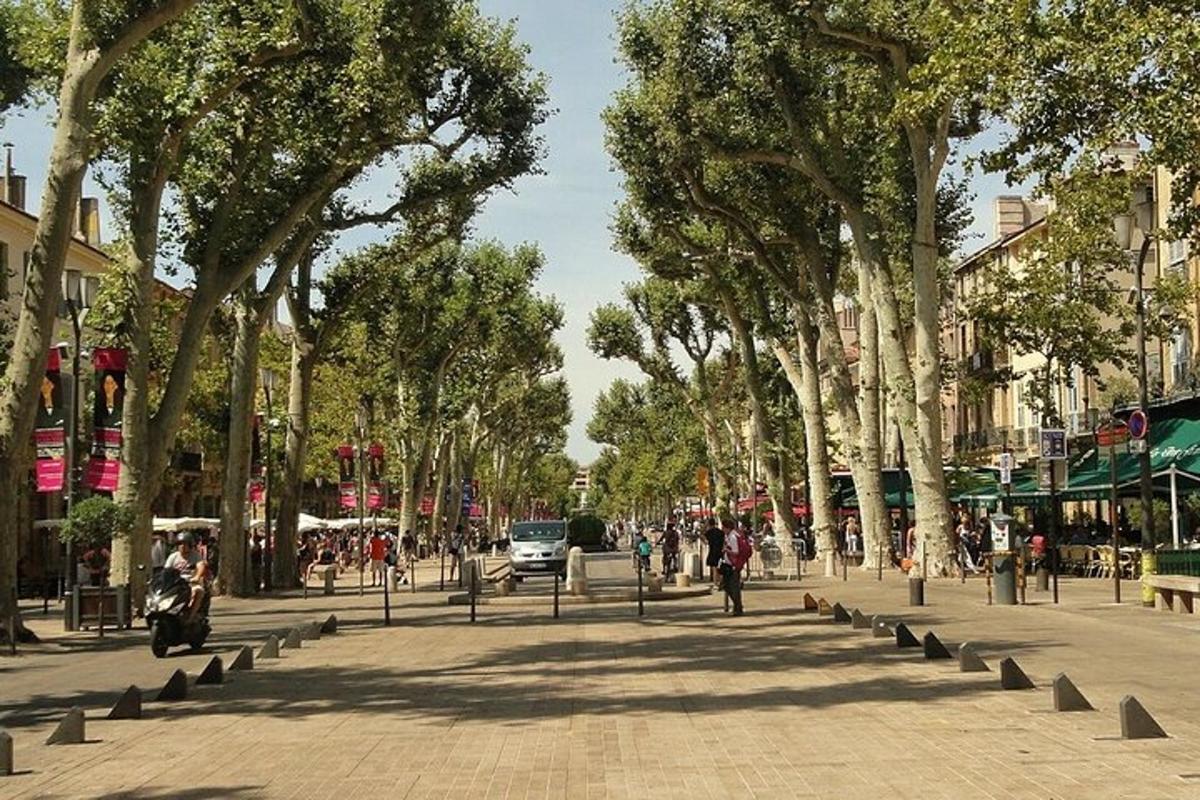 Una calle con árboles y gente caminando por una acera.