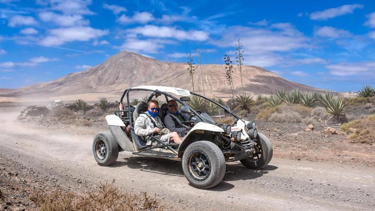two people in an atv driving in the desert