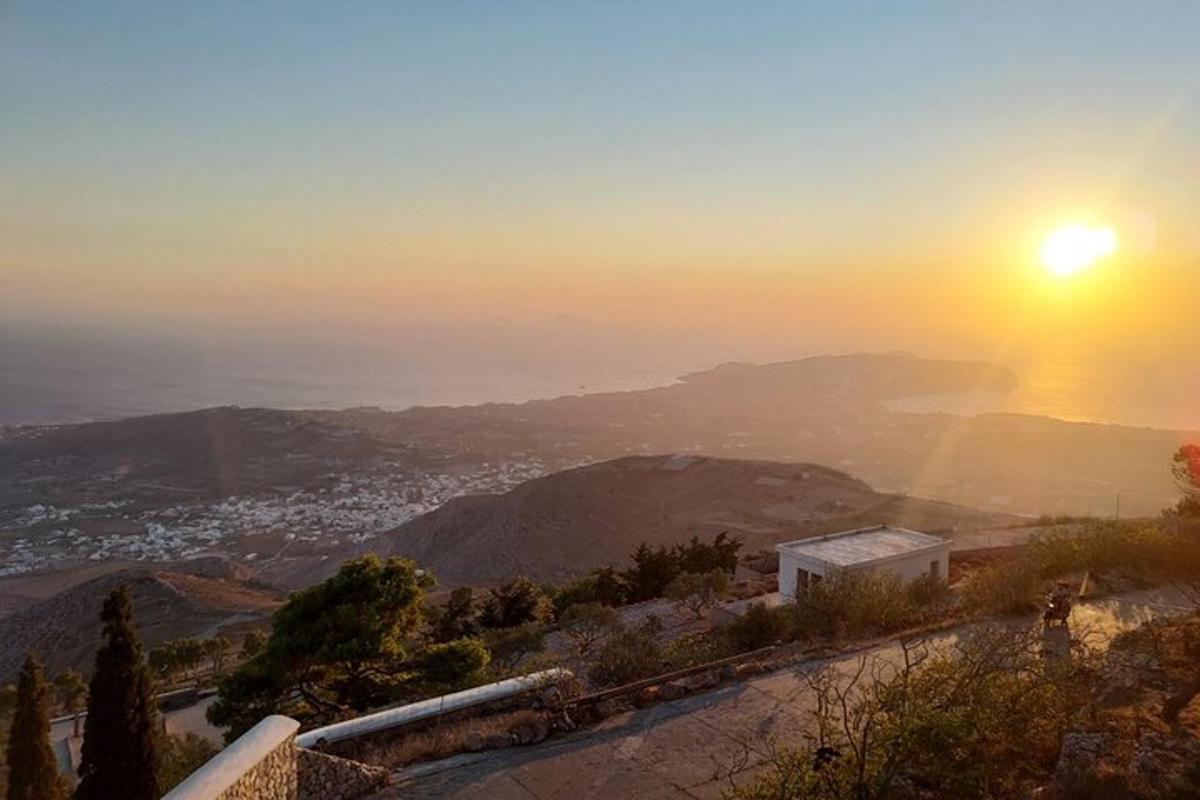 θέα του ηλίου που δύει πάνω από τα βουνά