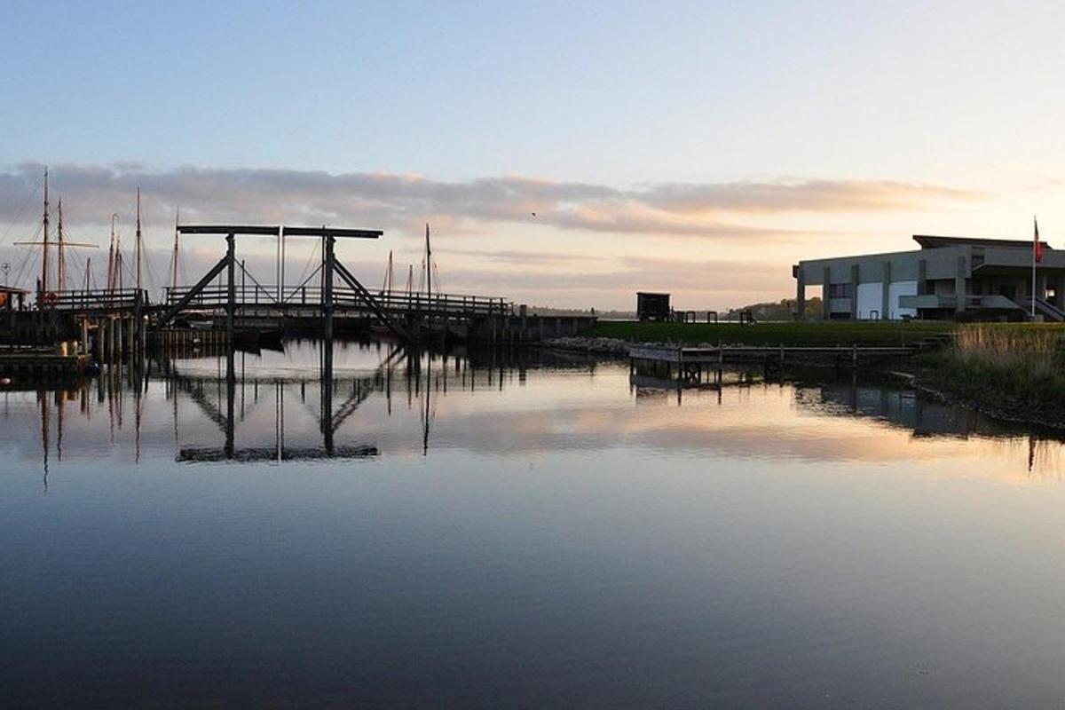 a dock on a body of water with a building